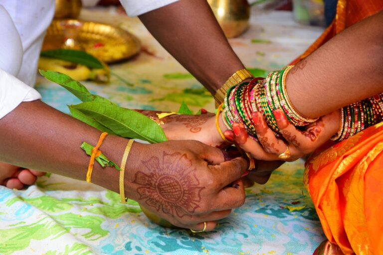 Close-up of a vibrant Hindu wedding ceremony featuring henna and bangles.