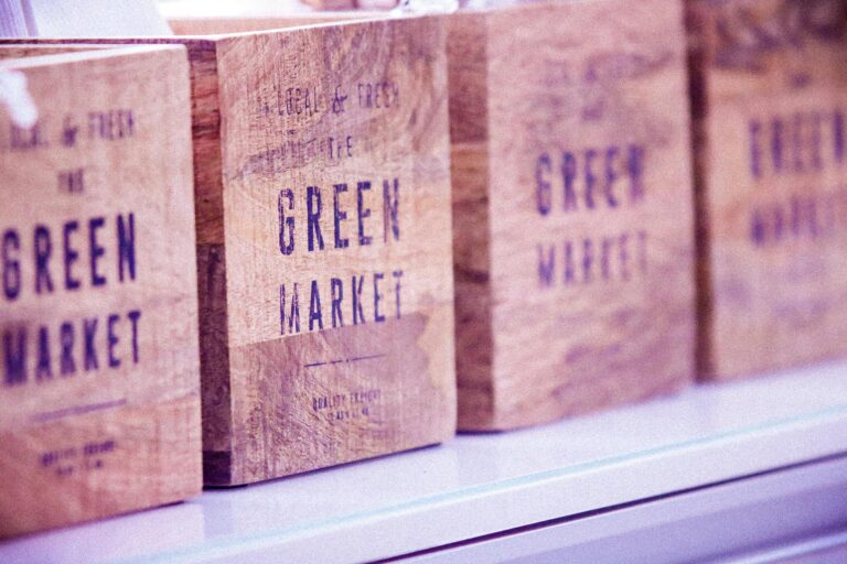 Close-up of vintage wooden boxes with green market text, ideal for commerce themes.