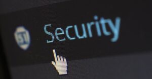 Close-up view of a mouse cursor over digital security text on display.