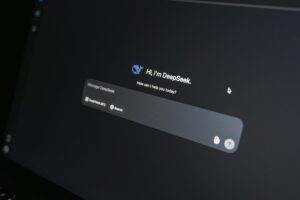 Close-up of DeepSeek AI chat interface on a laptop screen in low light.