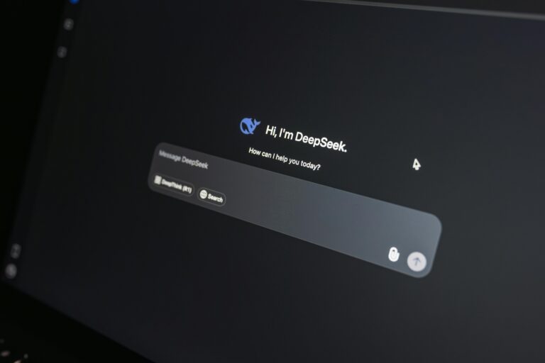Close-up of DeepSeek AI chat interface on a laptop screen in low light.